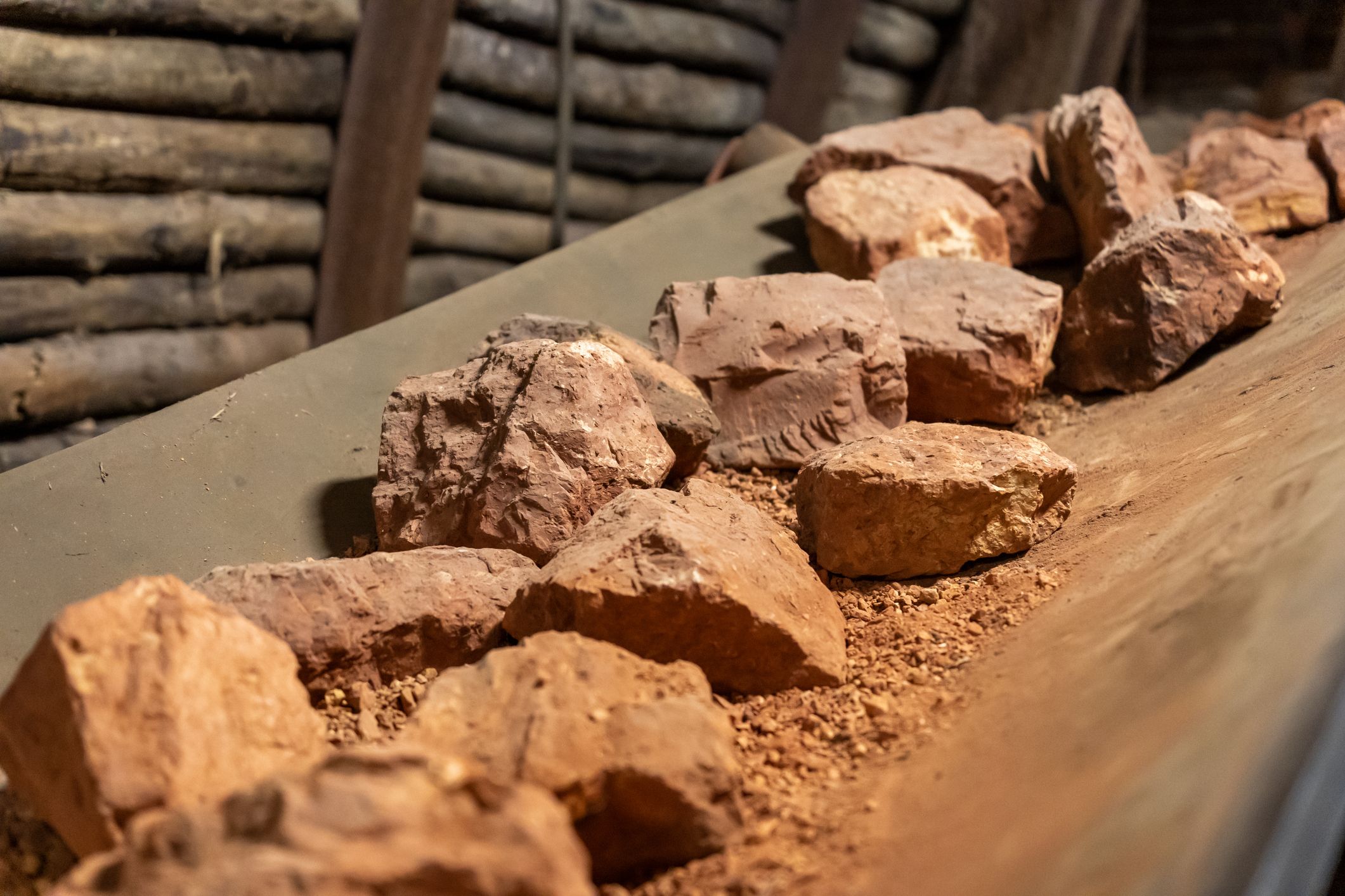Bauxite rocks on conveyor in mining tunnel