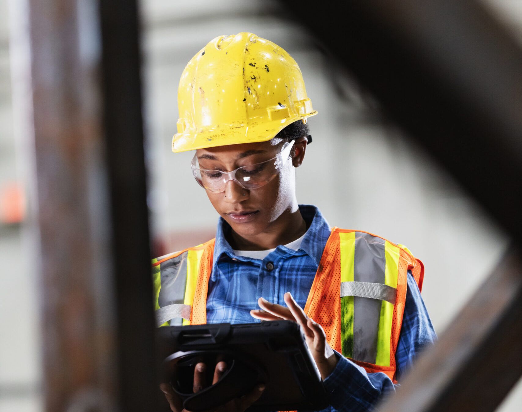 African-American woman using digital tablet in factory