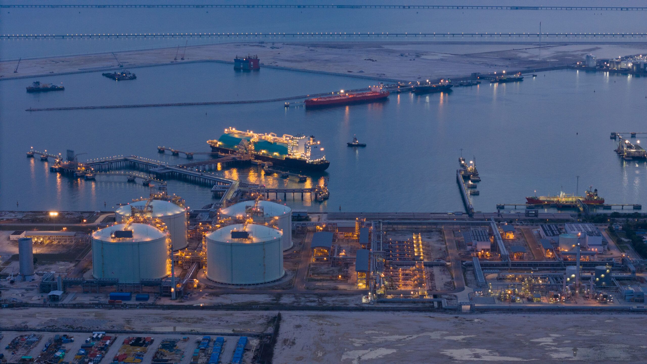 LNG (Liquified Natural Gas) tanker anchored in Gas terminal gas tanks for storage. Oil Crude Gas Tanker Ship. LPG at Tanker Bay Petroleum Chemical or Methane freighter export import transportation